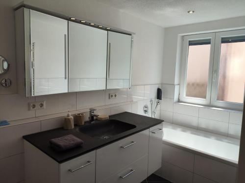 a white kitchen with a sink and a window at Eligo in Friedrichshafen