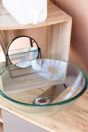 a glass bowl on top of a wooden shelf at La sphère étoilée in Ames