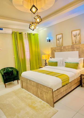 a bedroom with a large bed with green curtains at Green Paradise Hotel in Mogadishu