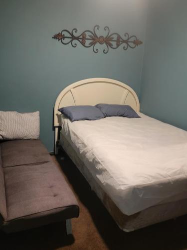 a bedroom with a bed with a bench next to it at ARMANI MANOR rustic spacious 2br unit 1 in Wildwood