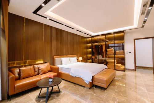 a bedroom with a bed and a couch at Biệt Thự FLC Sầm Sơn 7PN VIP BT43-02 in Sầm Sơn