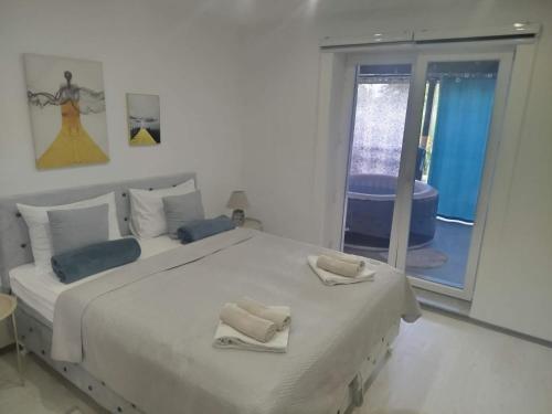 a bedroom with a large bed with two towels on it at Apt Amor in Bihać