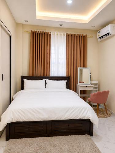a bedroom with a large bed and a red chair at Zenith Haven Casa de Padrillos in Imus