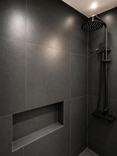 a bathroom with a shower with gray tile at Zenith Haven Casa de Padrillos in Imus