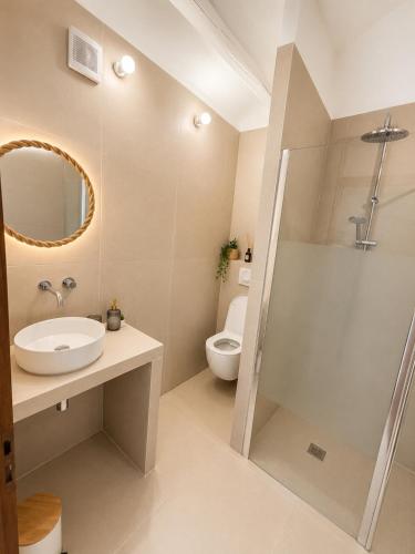 a bathroom with a sink and a toilet and a mirror at Studios Riviera in Bandol