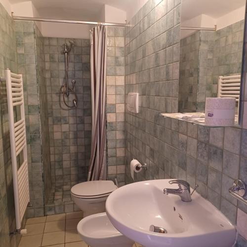a bathroom with a sink and a toilet and a shower at Don Goffredo in Monopoli