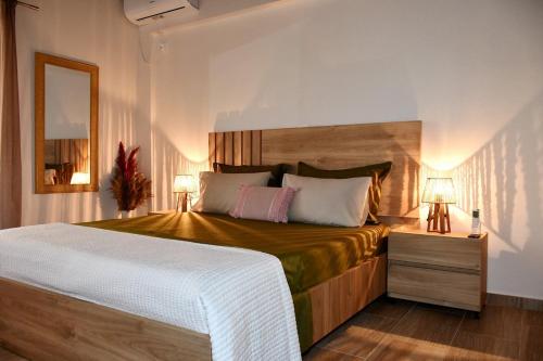 a bedroom with a large bed and two lamps at Kyma&Soul Seaview Loft in Xylokastro
