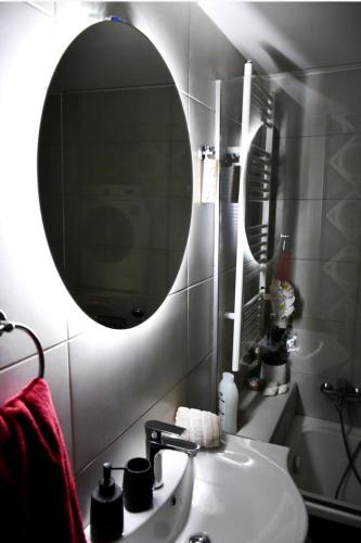 a bathroom with a sink and a mirror at Kyma&Soul Seaview Loft in Xylokastro