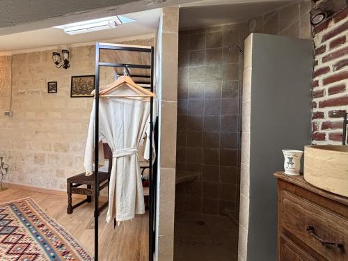 a bathroom with a walk in shower and a glass door at Grange d'époque à Chantilly in Chantilly