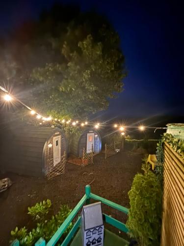 a group of tents at night with lights at Pentland View Campsite in Haywood