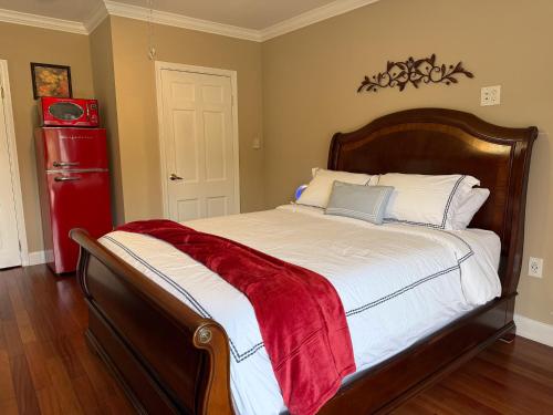 a bedroom with a bed with a red refrigerator at National Harbor Suite 2 in Fort Washington