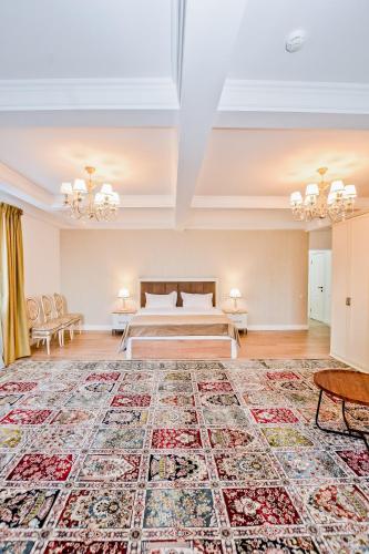 a bedroom with a bed and a large rug at Hotel Astoria, в самом центре города in Astana