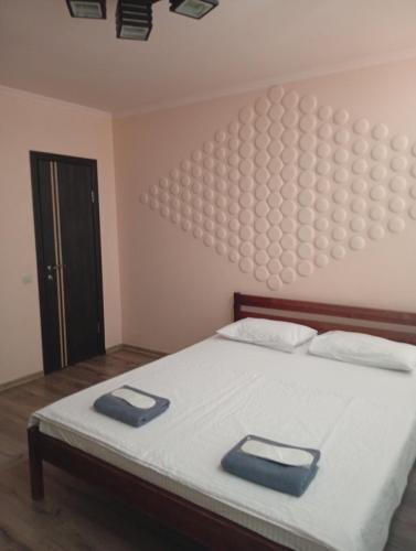 a bedroom with a bed with two pillows on it at Potemkin view suites in Odesa