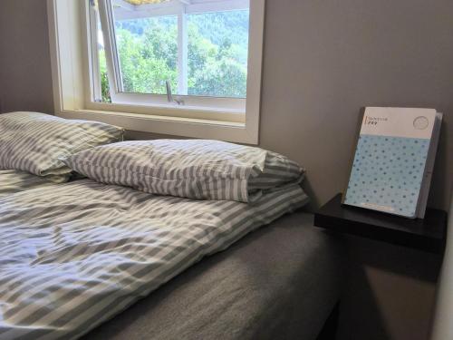 an unmade bed with a pillow and a window at Modern 1BR City Centre Apt - Sleeps 4 in Otta