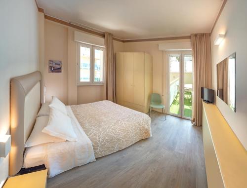 a bedroom with a bed and a television in it at Residence Capitol in Cattolica