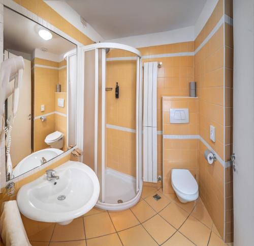 a bathroom with a sink and a shower and a toilet at Residence Capitol in Cattolica