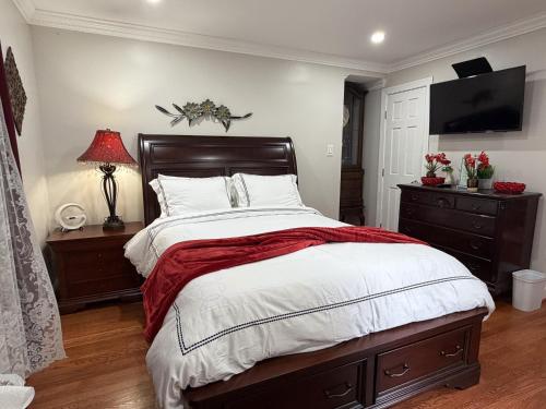a bedroom with a large bed with a red blanket at National Harbor Suite 3 in Fort Washington
