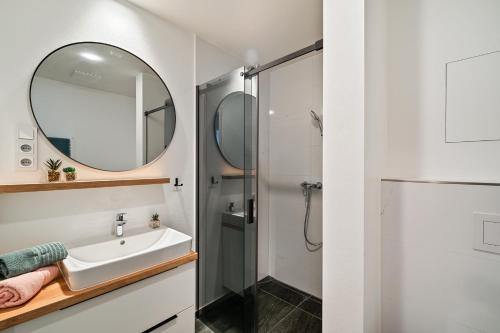 a bathroom with a sink and a shower at Apartmán Klement in Znojmo