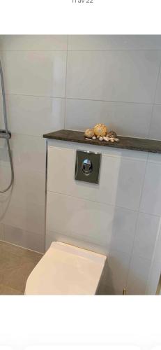 a bathroom with a toilet and a counter top at Tivoligatan in Höganäs