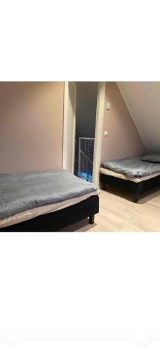 two beds are in a room with at Tivoligatan in Höganäs