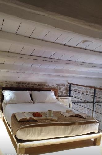 a large bed in a room with a white ceiling at La casetta in Trabia