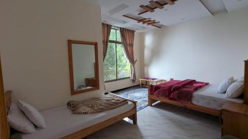a bedroom with a bed and a mirror and a couch at Cool Pine Hotel Nathia Gali in Abbottabad