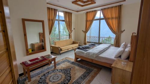 a bedroom with a large bed and a mirror at Cool Pine Hotel Nathia Gali in Abbottabad