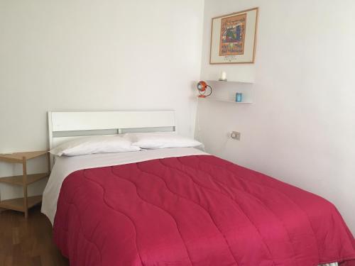 a bedroom with a large bed with a red blanket at BellaVista Bike Stop in Spoltore