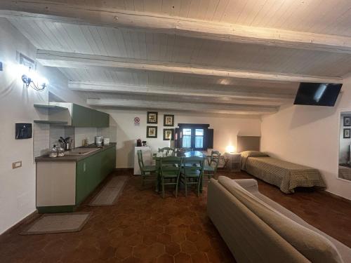a kitchen and a living room with a table and chairs at Soleluna in Syracuse