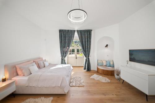 a bedroom with a bed and a tv and a window at Zámecký Apartmán Verde in Jince