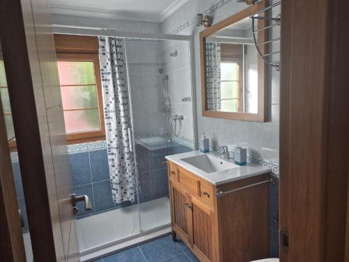 a bathroom with a sink and a shower at Casa Güelo in Muros de Nalón