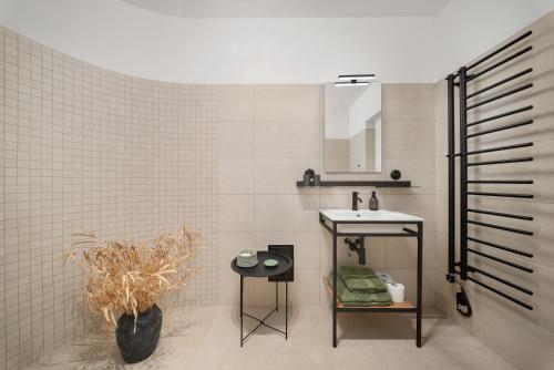 a bathroom with a sink and a toilet and a mirror at Zámecký Apartmán Verde in Jince