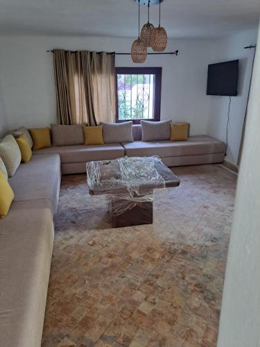 a living room with a couch and a coffee table at Villa Saif in Marina Smir
