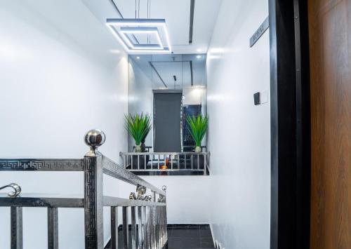 a hallway with a staircase with potted plants at One90 Apartment in Lagos