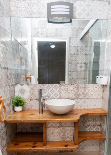 a bathroom with a sink and a mirror at casa maria in La Romana