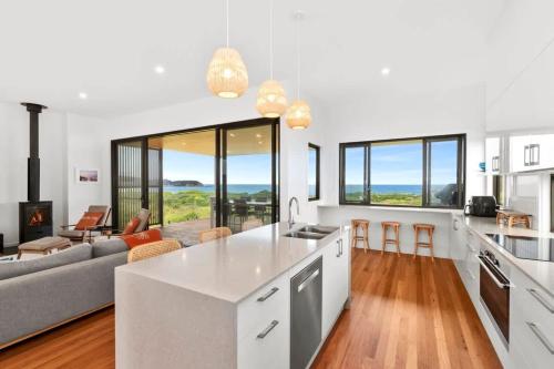 a kitchen and living room with a couch and a table at Dunes at Tomakin in Tomakin