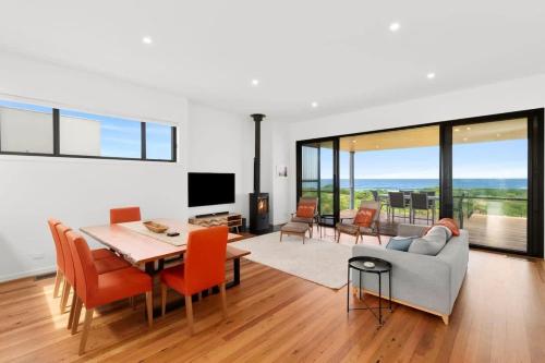 a living room with a table and a couch at Dunes at Tomakin in Tomakin