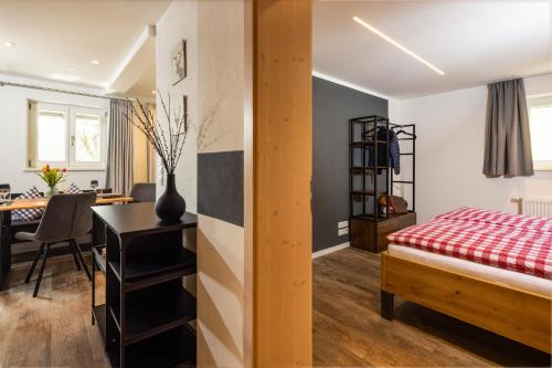 a bedroom with a bed and a desk and a table at Haus Vogl Anger - Ferienwohnungen mit privater Sauna und beheizten Salzwasser Pool in Panoramalage und Nähe zu Salzburg und Berchtesgaden in Anger