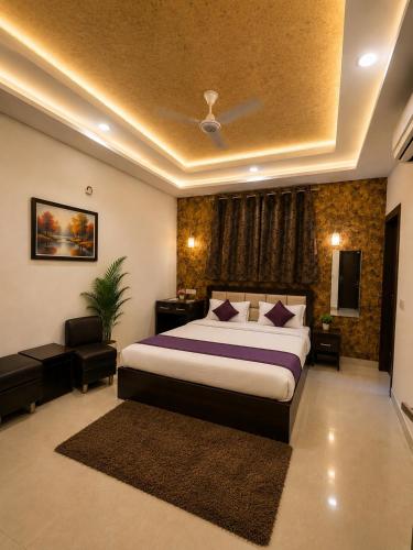 a bedroom with a king sized bed and a television at Hotel Star Grand - Premium Budget Hotel Near Taj mahal, in Agra
