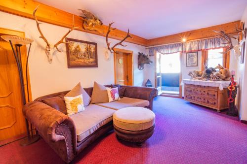 a living room with a couch and a table at Minzlhof in Ramsau am Dachstein