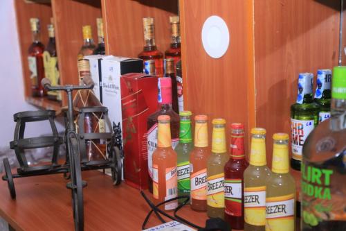 a row of bottles of alcohol on a shelf at La Bella resort in Mombasa