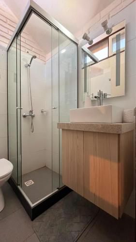a bathroom with a glass shower and a sink at Casa de campo en Punta Ballena in Punta del Este
