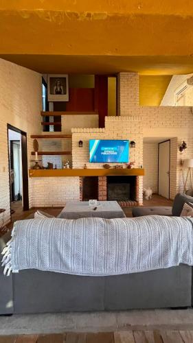 a large bed in a living room with a television at Casa de campo en Punta Ballena in Punta del Este