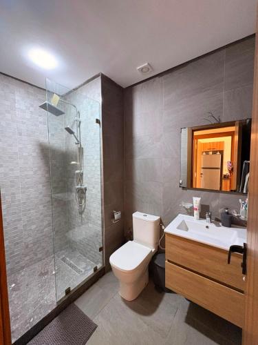 a bathroom with a shower and a toilet and a sink at Magic House T5 -El Mansouria in Mansouria