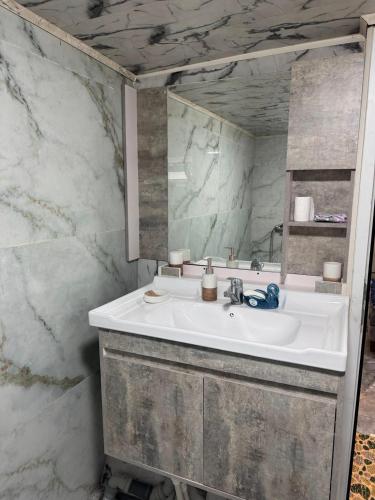 a bathroom with a white sink and a mirror at xanagah aframe in Qala