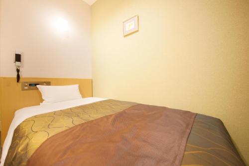 a bedroom with a bed in a room at Hotel Grand City in Tokyo