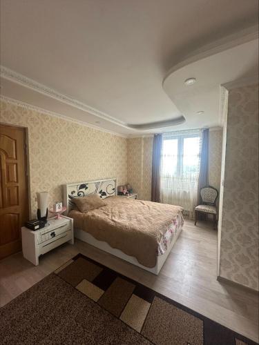 a bedroom with a large bed and a window at house chito in Tsqaltubo