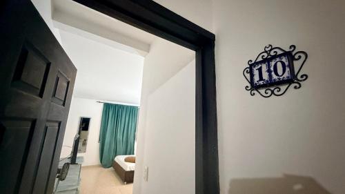 a door to a room with a clock on the wall at hotel turqueza inn in Armenia