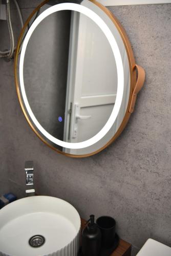 a bathroom sink with a large mirror on the wall at Feli Lodge in Bosanska Gradiška