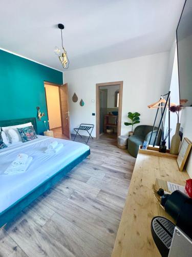 a bedroom with a large bed and a living room at Escape Room 04 in Tirano